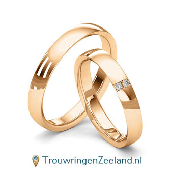 Trouwringen in 8*/14/18 karaat geelgoud glans gepolijst 3,5 mm. breed met in de damesring 2 x 0.015 ct diamanten overdwars gezet