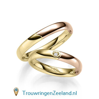 Trouwringen in 14 of 18 karaat witgoud glad gepolijst 4,0 mm. breedte met in de damesring 1 diamant in een hart gezet per paar 