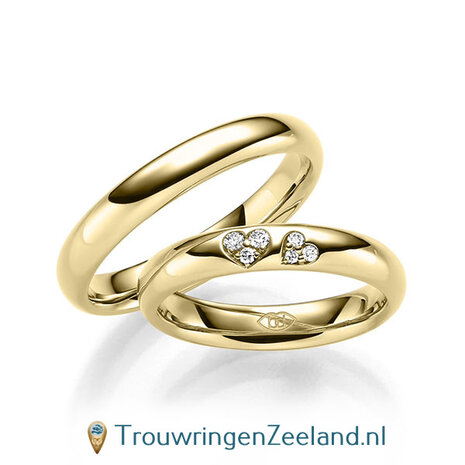 Trouwringen in 14/18 karaat witgoud glans gepolijst met in de damesring 6 diamanten in 2 hartjes gezet 0,065 ct 
