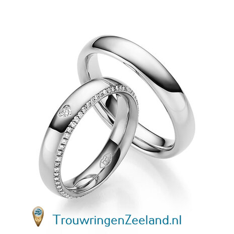 Trouwringen in 14/18 karaat witgoud glans gepolijst 5,0 mm. breedte en in de damesring 57 diamanten gezet in de zijkant en bovenop 1 hartdiamant per paar vanaf