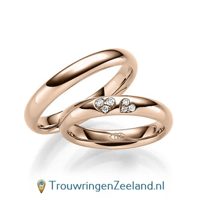 Trouwringen in 14/18 karaat roodgoud glans gepolijst met in de damesring 6 diamanten in 2 hartjes gezet 0,065 ct